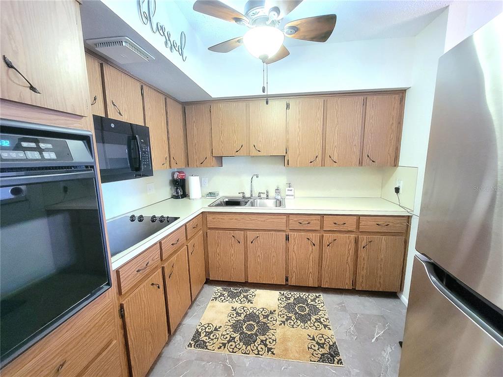 2371 Israeli Drive, Unit 39 Clearwater, FL 33763 - Photo 7 of 34 a kitchen with a sink cabinets and window