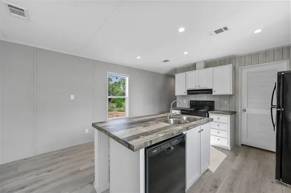 a kitchen with a stove a sink and a refrigerator
