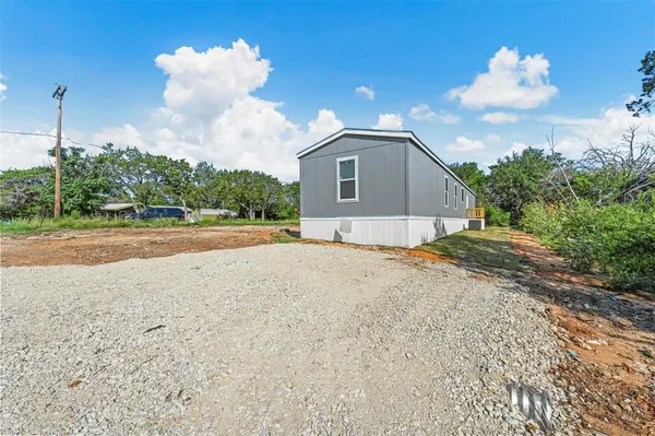 a view of a house with a backyard