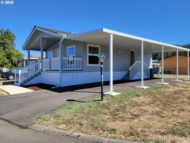 a backyard of a house with shaded area