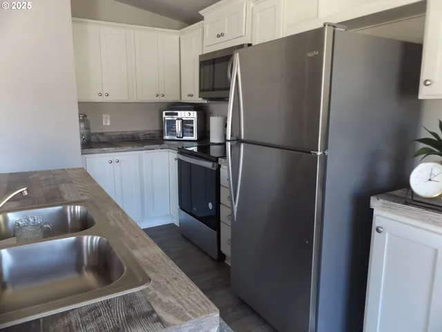 a kitchen with a refrigerator sink and microwave