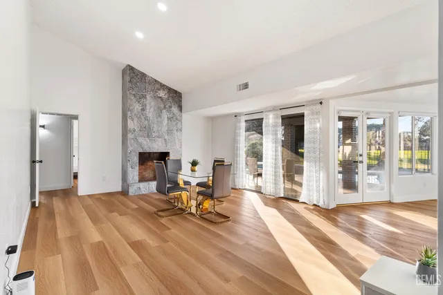 a living room with furniture a fireplace and a table