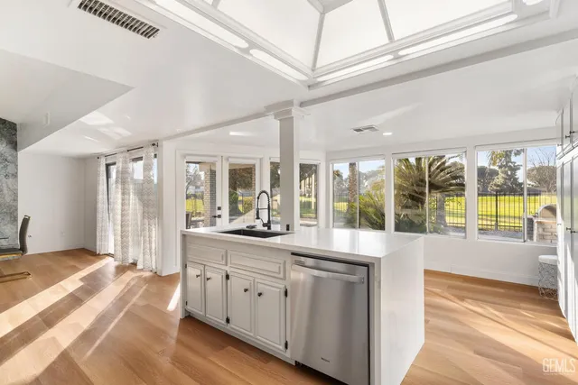 a open kitchen with granite countertop a large window