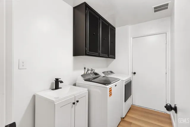 a utility room with sink dryer and washer