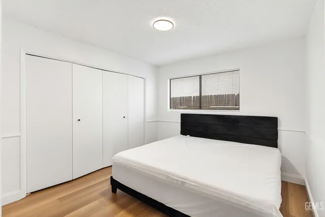 a room with a bed and a night stand