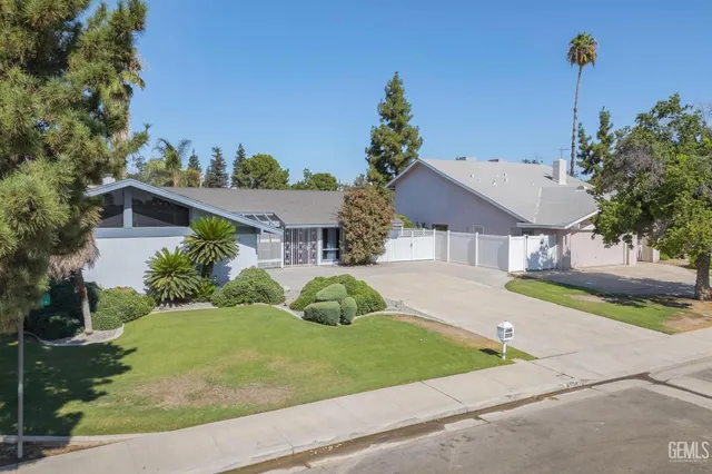 a house with green field in front of it