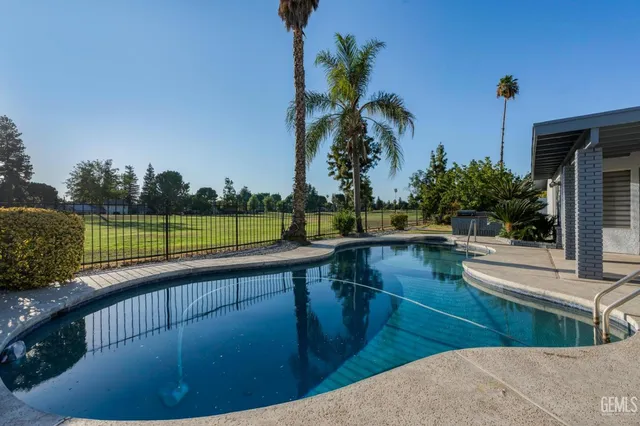 a view of a swimming pool with a patio
