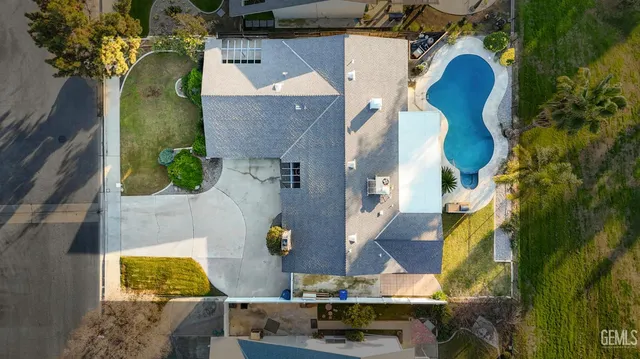 an aerial view of residential house with outdoor space and swimming pool