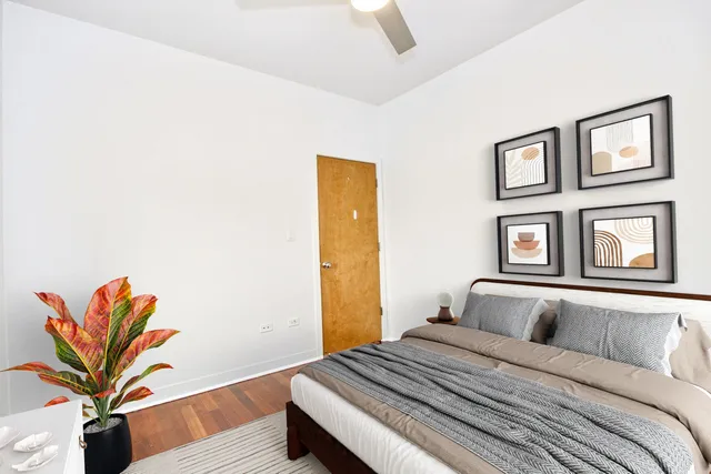 a bedroom with a bed and a painting on the wall