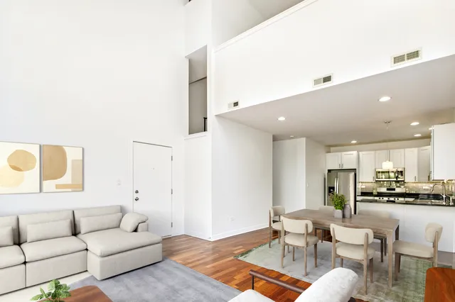a living room with furniture and kitchen view