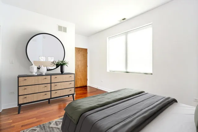 a bedroom with a bed and a dresser