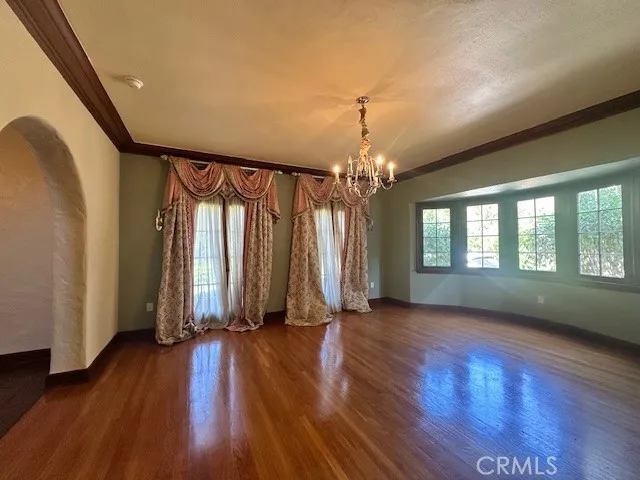a view of a room with wooden floor and windows