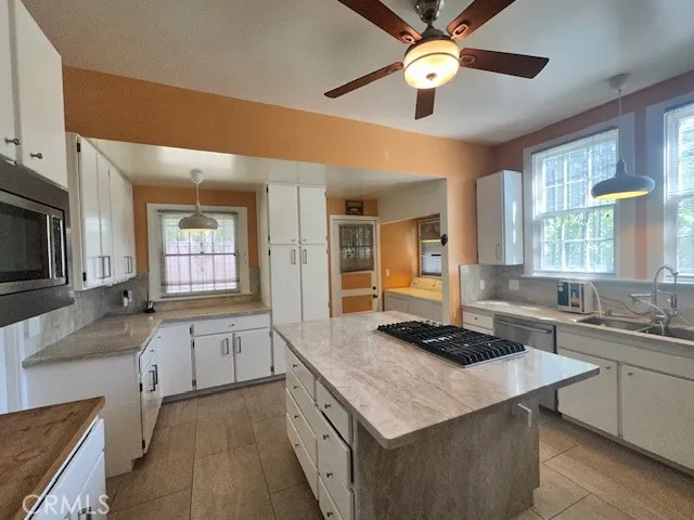 a kitchen with a stove a sink and a refrigerator
