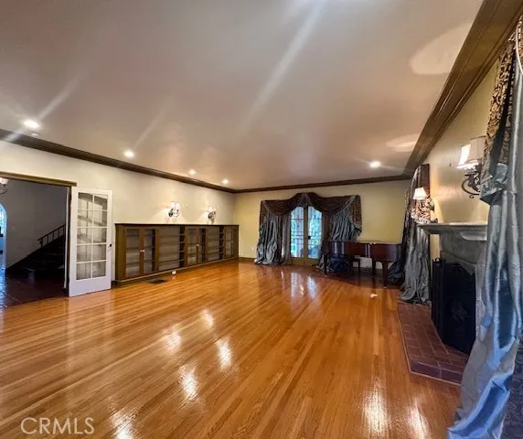 a view of a livingroom with a fireplace and wooden floor