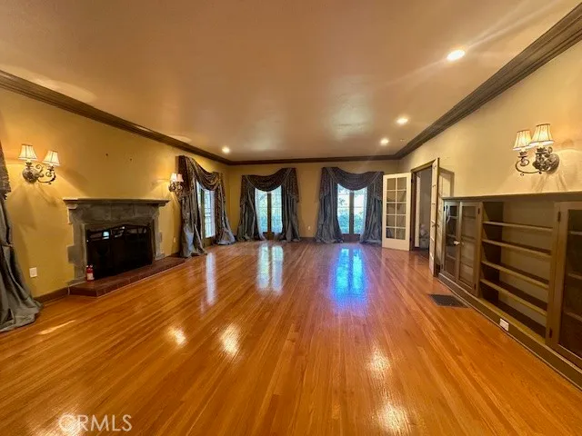 a living room with wooden floors and a fireplace
