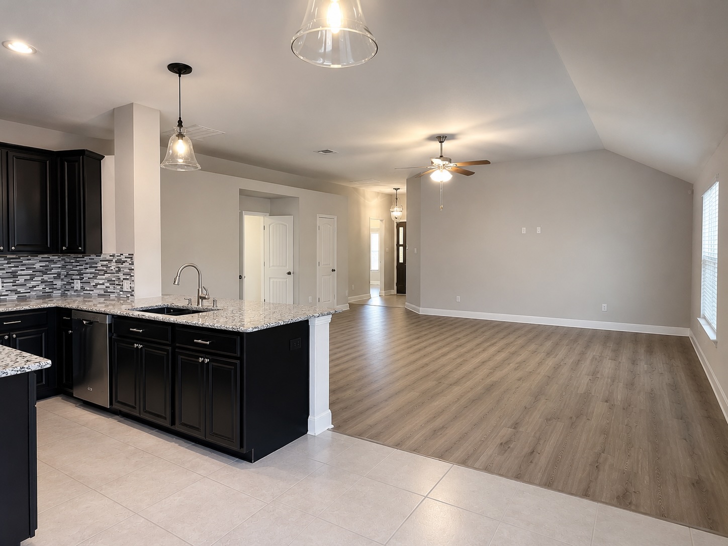 18512 Rio Chama Lane Austin, TX 78738 - Photo 10 of 20 Gleaming tiled floors transition to warm wood-look planks in this inviting open-concept layout.