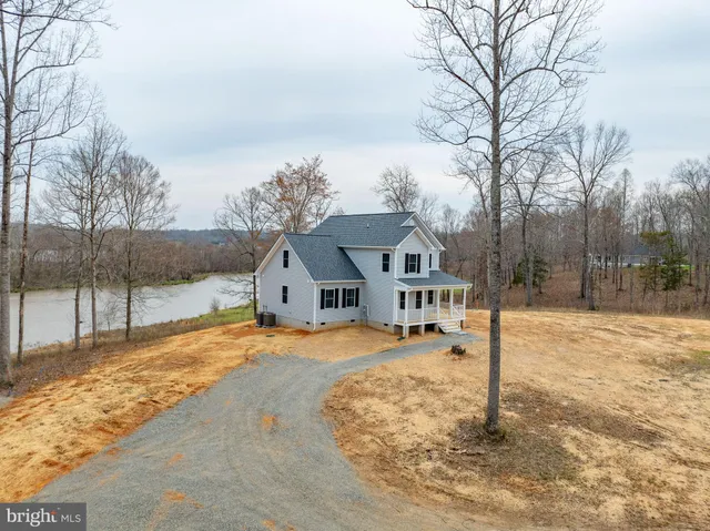 a front view of a house with a yard covered in snow