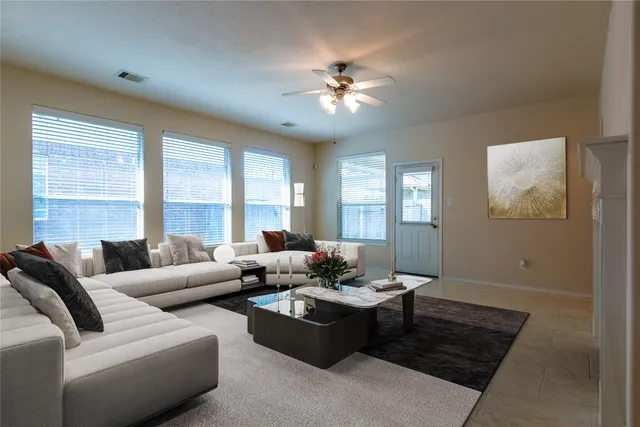 a living room with furniture and a large window