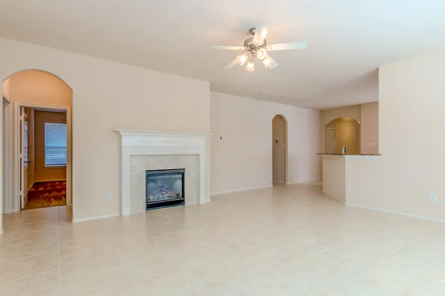 a view of an empty room with a fireplace
