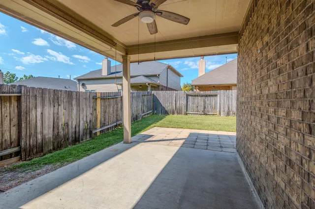 a view of a house with backyard and porch