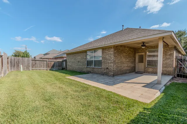 an aerial view of a house with outdoor space and lake view