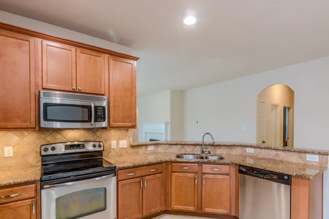 a kitchen with a sink stove and microwave