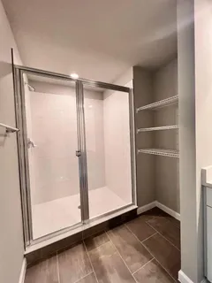 a spacious bathroom with a double vanity sink and a mirror
