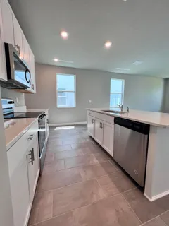 a kitchen with a sink and a stove top oven