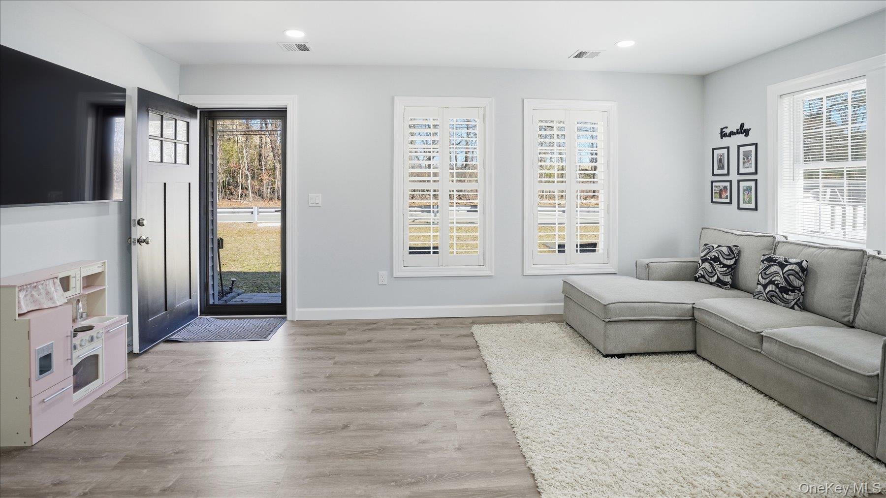 130 Beaver Dam Road Brookhaven, NY 11719 - Photo 11 of 30 Living area featuring light wood-style floors and recessed lighting