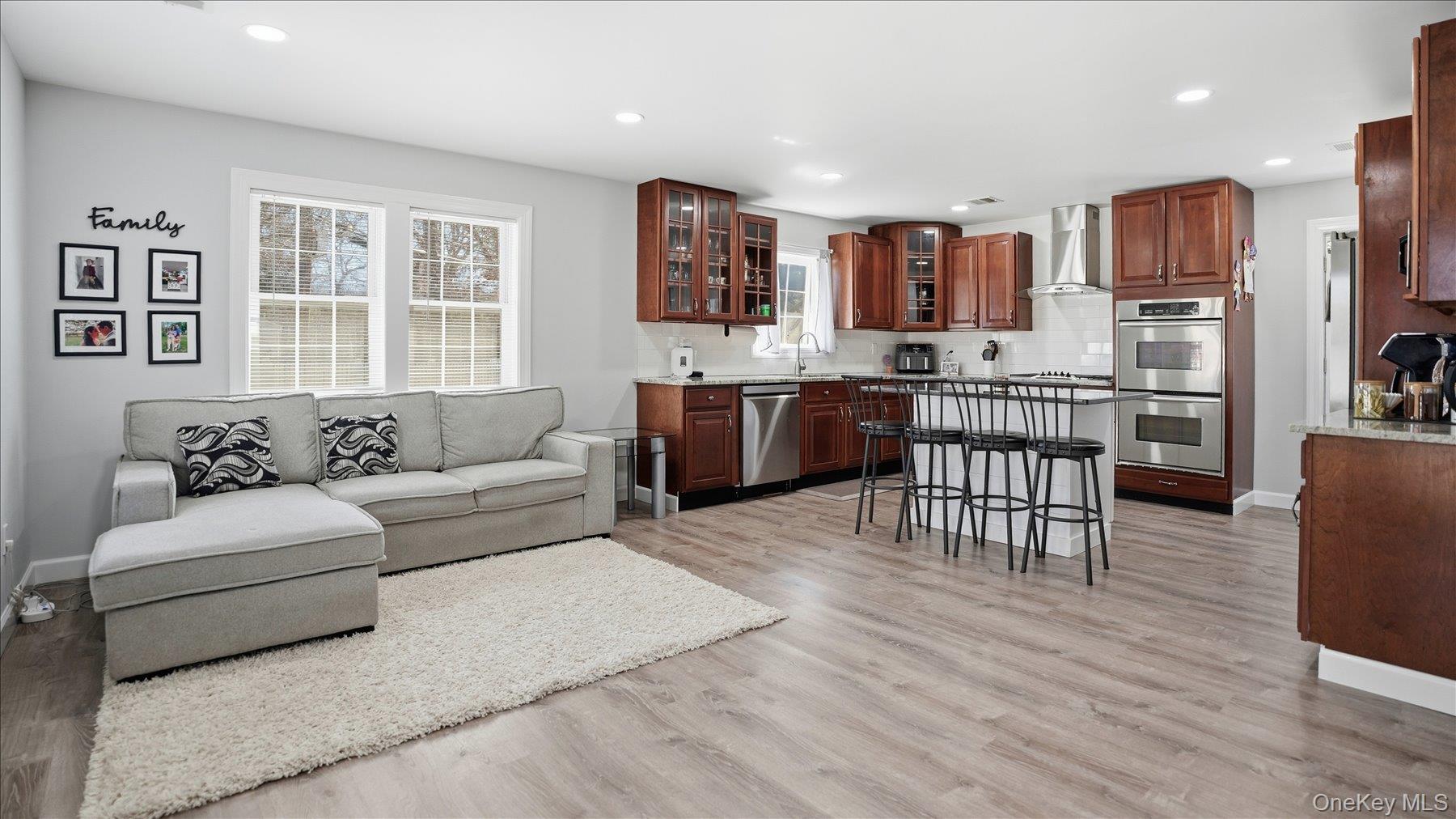 130 Beaver Dam Road Brookhaven, NY 11719 - Photo 12 of 30 Living area with light wood-style flooring and recessed lighting