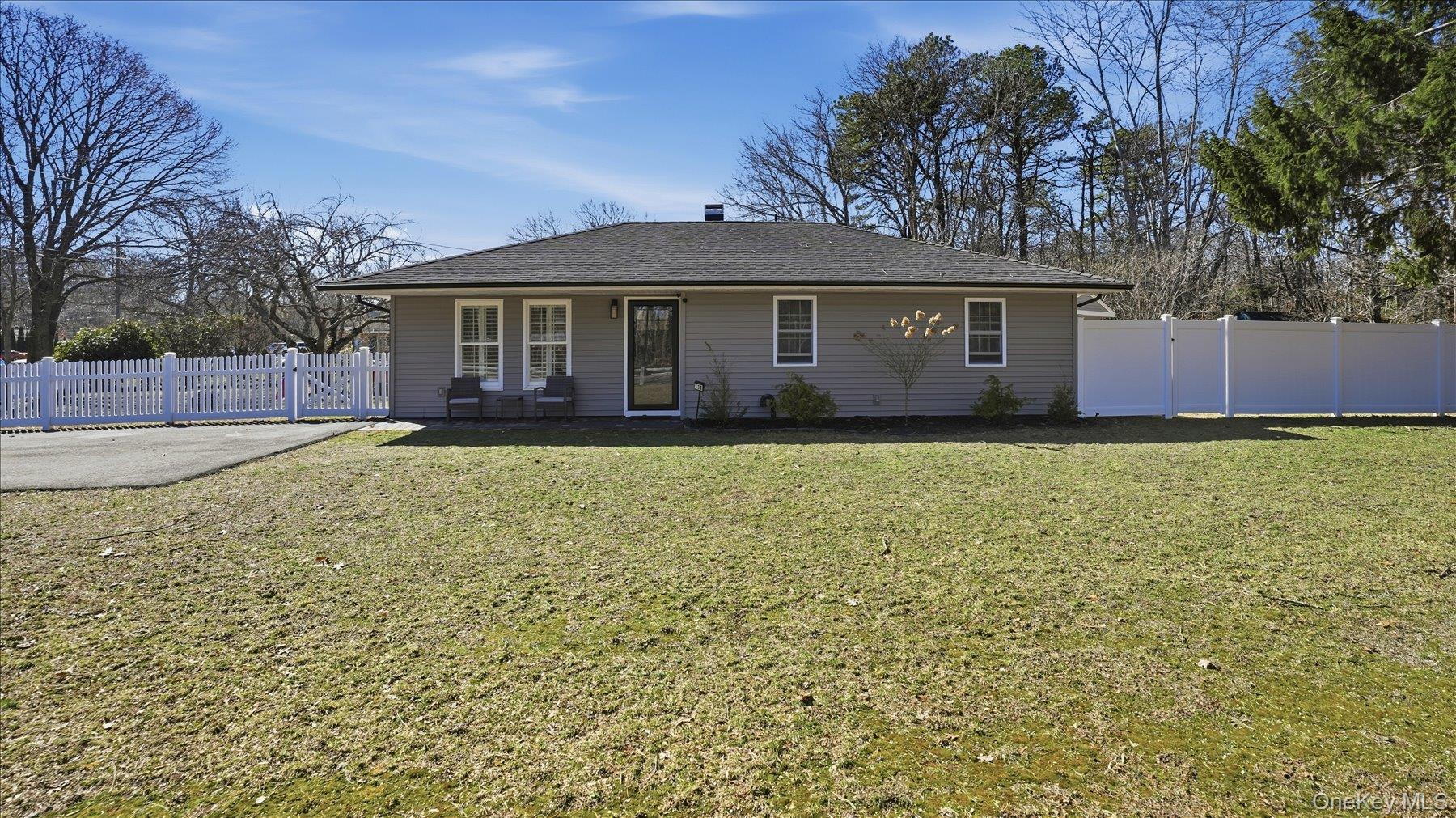 130 Beaver Dam Road Brookhaven, NY 11719 - Photo 2 of 30 Rear view of house with a chimney and a patio area
