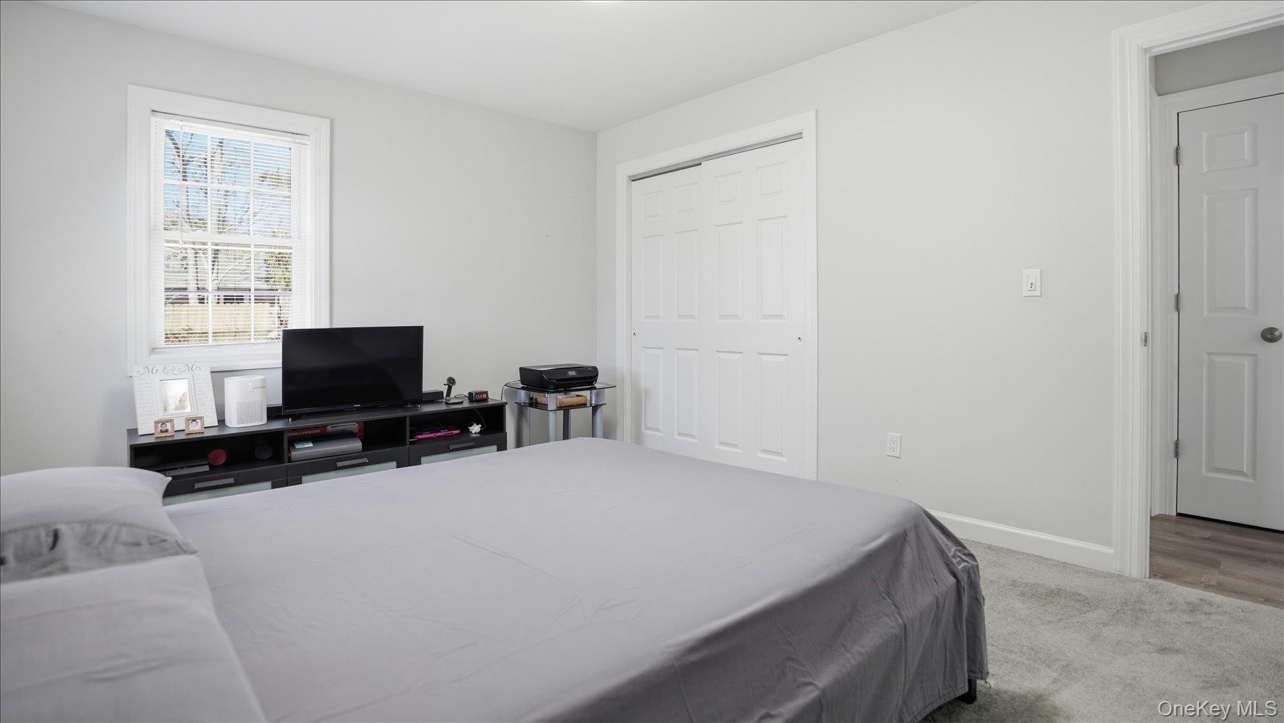 130 Beaver Dam Road Brookhaven, NY 11719 - Photo 21 of 30 Carpeted bedroom featuring baseboards and a closet