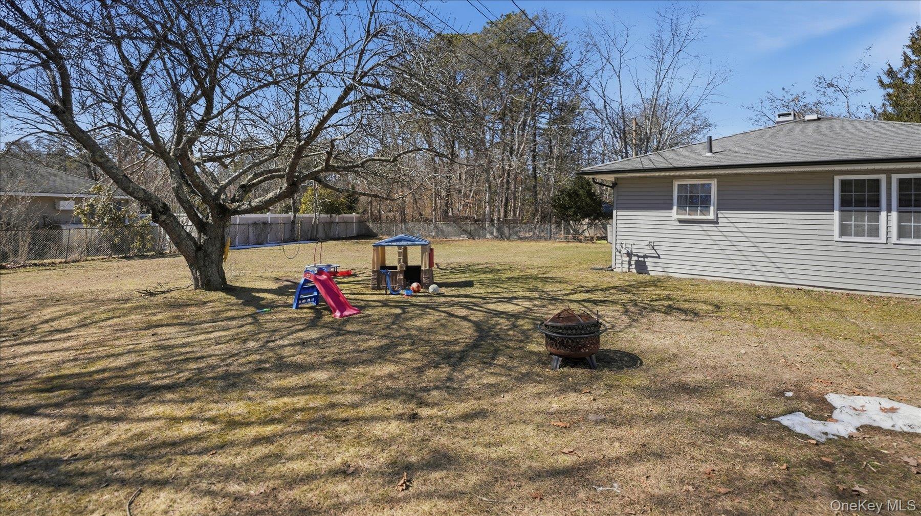 130 Beaver Dam Road Brookhaven, NY 11719 - Photo 30 of 30 Fenced yard featuring a fire pit