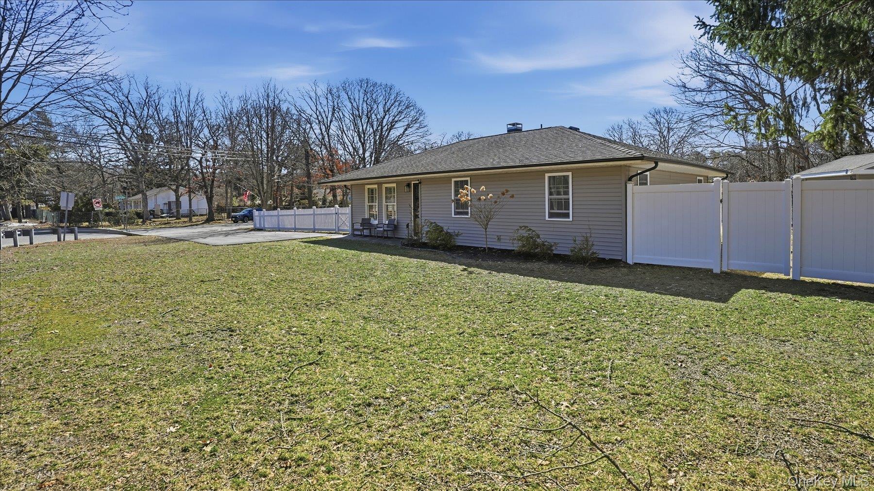 130 Beaver Dam Road Brookhaven, NY 11719 - Photo 3 of 30 View of property exterior featuring a shingled roof and a gate