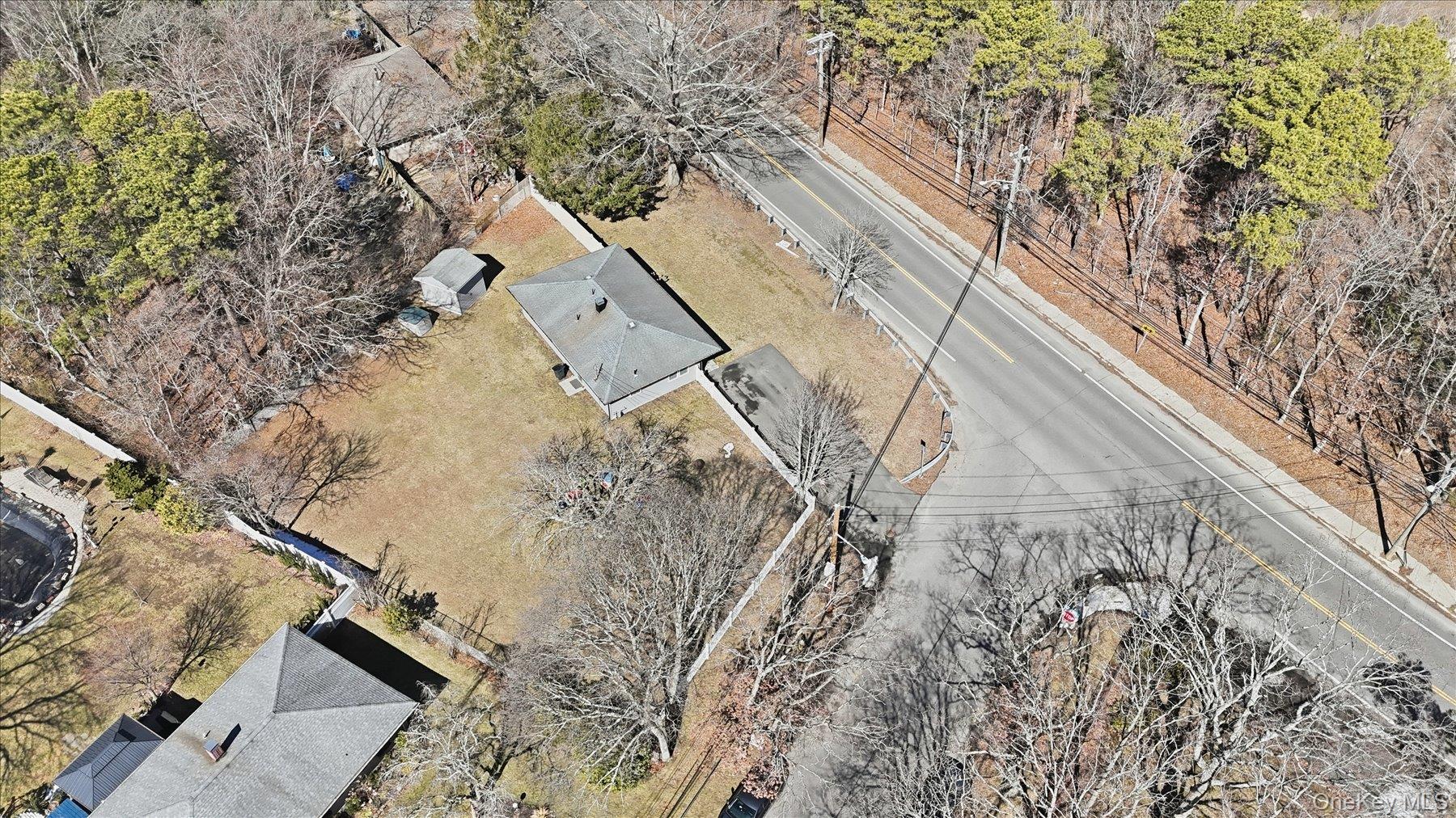 130 Beaver Dam Road Brookhaven, NY 11719 - Photo 6 of 30 View from above of property featuring a tree filled landscape