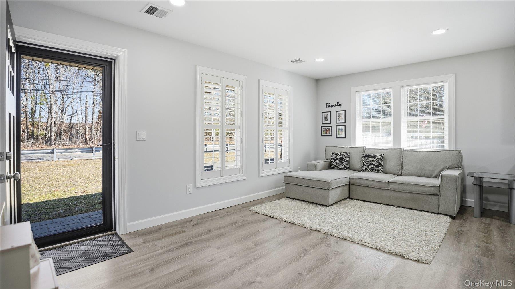 130 Beaver Dam Road Brookhaven, NY 11719 - Photo 10 of 30 Living room featuring light wood-style flooring, plenty of natural light, and recessed lighting