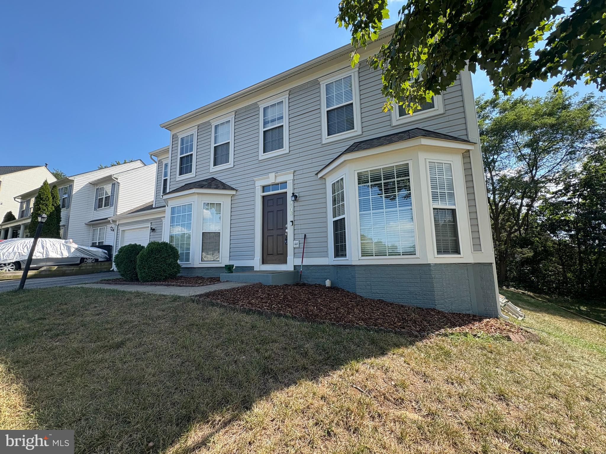 3108 Butterfly Way Dumfries, VA 22026 - Photo 2 of 8 a front view of a house with a yard
