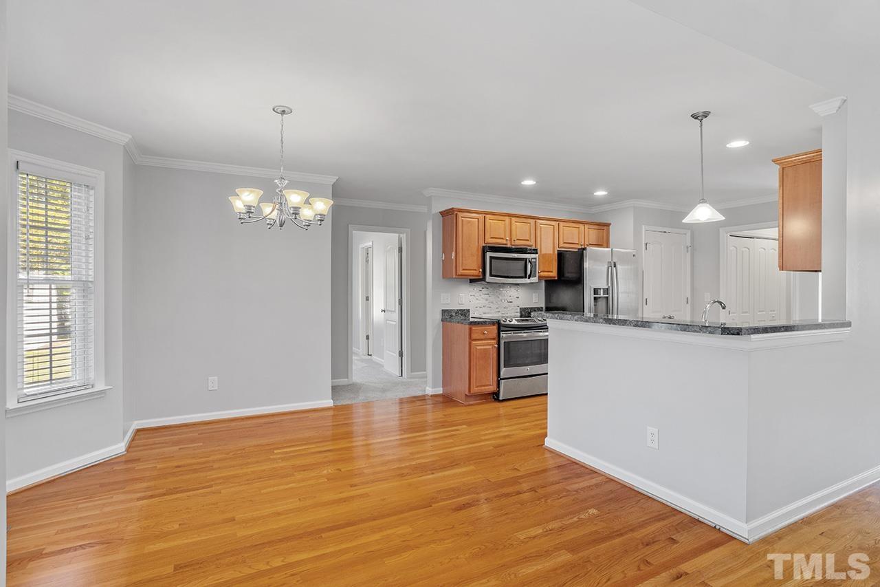 71 Charlie Reade Road Timberlake, NC 27583 - Photo 23 of 33 a view of kitchen with kitchen island granite countertop refrigerator cabinets and wooden floor