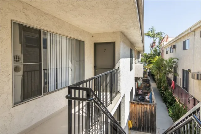 a view of balcony with wooden floor and fence