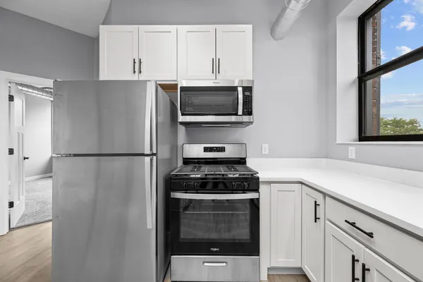a kitchen with a refrigerator stove and microwave