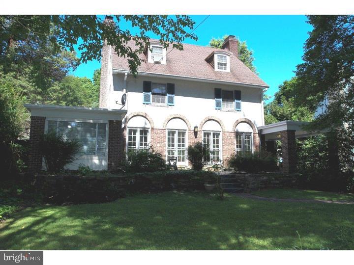 a front view of a house with garden and patio