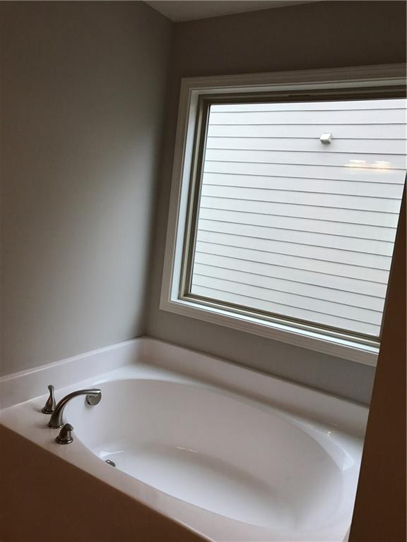 5934 Watersdown Way Flowery Branch, GA 30542 - Photo 17 of 28 a bathroom with a bathtub and shower