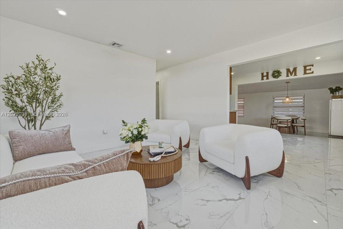 120 West 50th Street Hialeah, FL 33012 - Photo 1 of 22 a spacious bedroom with a bed and a couch
