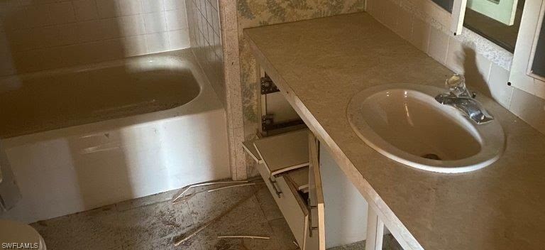 3579 Unique Circle Fort Myers, FL 33908 - Photo 5 of 6 a bathroom with a sink and washing machine