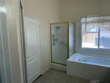 a bathroom with a bathtub and shower