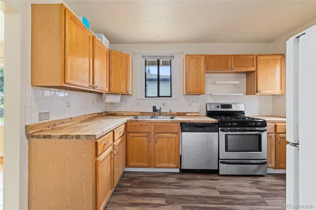 a kitchen with stainless steel appliances granite countertop a stove and a sink