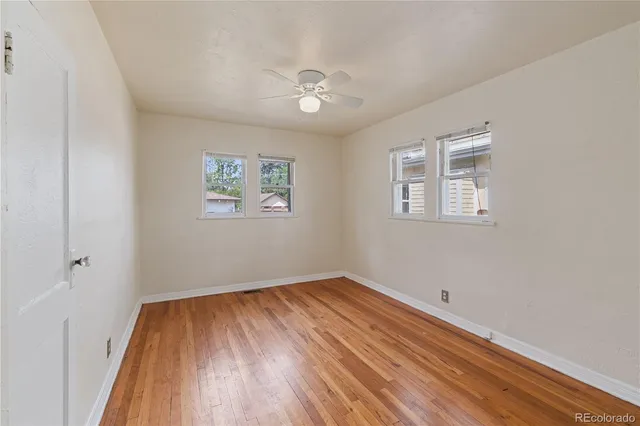 a view of a room with wooden floor and a window