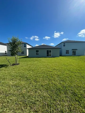 a view of a patio with a table and chairs