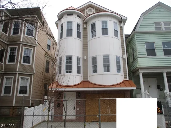 a front view of a residential apartment building with a yard