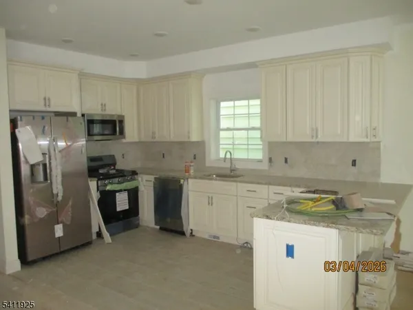 a kitchen with a sink stove and refrigerator